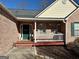 Brick front porch with green door and white railing at 504 Plantation Creek Dr, Loganville, GA 30052