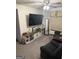 Cozy living room with large TV, storage cabinet, and comfortable seating at 504 Plantation Creek Dr, Loganville, GA 30052