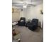 Comfortable living room area featuring two black armchairs and neutral decor at 504 Plantation Creek Dr, Loganville, GA 30052