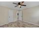 Bedroom with wood-look floors, ceiling fan, and access to hallway at 1256 Elizabeth Sw Ave, Atlanta, GA 30310