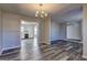 Open concept dining room with new flooring and chandelier at 5495 Reynolds Rd, Morrow, GA 30260