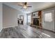 Living room featuring a stone fireplace and grey vinyl flooring at 5495 Reynolds Rd, Morrow, GA 30260