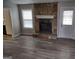 Stone fireplace and grey vinyl flooring in living room at 5495 Reynolds Rd, Morrow, GA 30260