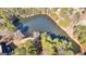 Aerial view of a serene lake surrounded by lush trees at 120 Greenfield Cir, Fayetteville, GA 30215