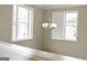 View of a dining room with large windows and chandelier at 4879 Pinnacle Dr, Stone Mountain, GA 30088