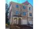 Three-story townhome with stone exterior at 4879 Pinnacle Dr, Stone Mountain, GA 30088