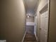 Long hallway with wood floors and neutral walls at 4879 Pinnacle Dr, Stone Mountain, GA 30088