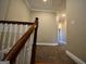 Upper hallway with wood railing and carpeted flooring at 4879 Pinnacle Dr, Stone Mountain, GA 30088