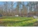 Spacious backyard with storage shed and wooded area at 718 Grove Pointe Cir, Locust Grove, GA 30248