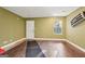 Unfinished basement with wood flooring, door, and window at 718 Grove Pointe Cir, Locust Grove, GA 30248