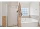 Bathroom with shower and tub, and tile surround at 718 Grove Pointe Cir, Locust Grove, GA 30248