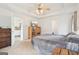 Bright bedroom featuring a king-size bed and built-in shelving at 718 Grove Pointe Cir, Locust Grove, GA 30248