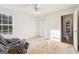 Well-lit bedroom featuring a window, carpet flooring, and built-in closet at 718 Grove Pointe Cir, Locust Grove, GA 30248