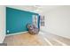 Bright bedroom with teal accent wall, carpet flooring, and a window offering natural light at 718 Grove Pointe Cir, Locust Grove, GA 30248