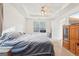 Spacious bedroom with ceiling fan and large window at 718 Grove Pointe Cir, Locust Grove, GA 30248