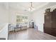 Simple dining room with window, hardwood floors, and storage at 718 Grove Pointe Cir, Locust Grove, GA 30248