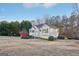 Side view of the house showcasing a large yard and wooded area at 718 Grove Pointe Cir, Locust Grove, GA 30248