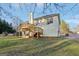 Two-story house with deck and stairs leading to backyard at 718 Grove Pointe Cir, Locust Grove, GA 30248