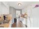 Kitchen boasts white cabinets, tile backsplash, and wood-look flooring at 718 Grove Pointe Cir, Locust Grove, GA 30248