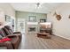 Living room featuring a fireplace, flat-screen TV, and comfortable seating at 718 Grove Pointe Cir, Locust Grove, GA 30248