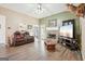 Living room with a stone fireplace, hardwood floors, and comfortable furniture at 718 Grove Pointe Cir, Locust Grove, GA 30248