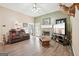 Living room featuring a fireplace, hardwood floors, and a large screen TV at 718 Grove Pointe Cir, Locust Grove, GA 30248