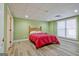 Finished basement bedroom with wood-look floors and large window at 145 Havenbrooke Ct, Fayetteville, GA 30214