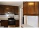 Kitchen with ample dark wood cabinets and a built-in desk area at 2405 Falls River Dr, Lithia Springs, GA 30122