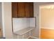 Dark wood kitchen cabinets and built-in desk at 2405 Falls River Dr, Lithia Springs, GA 30122