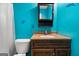 Clean bathroom with teal walls and a wood vanity at 5552 Smithfield Rd, Bowdon, GA 30108