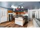 Kitchen with island, wooden cabinets, and pot rack at 5552 Smithfield Rd, Bowdon, GA 30108