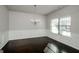 Bright dining room with wainscoting, dark hardwood floors, and a chandelier, great for entertaining or Gathering meals at 5345 Bucknell Trce, Cumming, GA 30028