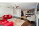 Open living room with hardwood floors, fireplace, and view of kitchen, with contemporary furnishings at 5345 Bucknell Trce, Cumming, GA 30028