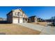 Wide street view of a two-story brick home with a large front yard and extended driveway at 5345 Bucknell Trce, Cumming, GA 30028