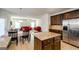 Open concept kitchen with granite countertops, stainless appliances, and access to the living area at 5345 Bucknell Trce, Cumming, GA 30028