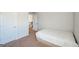 Modest bedroom featuring plush carpeting, a simple bed, and a view of the stairs at 5345 Bucknell Trce, Cumming, GA 30028