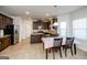Spacious kitchen with stainless steel appliances, center island, and dark wood cabinetry, adjacent to dining area at 5345 Bucknell Trce, Cumming, GA 30028