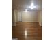 Large basement area with hardwood floors and a door at 793 Pixley Dr, Riverdale, GA 30296
