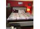 Spacious bedroom with king-size bed and red accent wall at 793 Pixley Dr, Riverdale, GA 30296