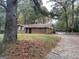 Brick ranch house with a long driveway and mature trees at 793 Pixley Dr, Riverdale, GA 30296