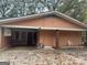 Peach-colored house with covered porch and detached garage at 793 Pixley Dr, Riverdale, GA 30296
