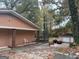 Peach-colored house with covered porch, detached garage, and a car at 793 Pixley Dr, Riverdale, GA 30296