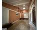Long interior hallway with peach walls and skylight at 793 Pixley Dr, Riverdale, GA 30296
