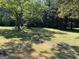 Large backyard with lush green grass and trees at 6074 Shallow Wood Ln, Douglasville, GA 30135