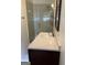 Bathroom with glass shower and dark vanity at 6074 Shallow Wood Ln, Douglasville, GA 30135