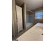 Bathroom with light vanity, tub and tile floor at 6074 Shallow Wood Ln, Douglasville, GA 30135