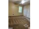 Bedroom with carpet, window, and built-in closet at 6074 Shallow Wood Ln, Douglasville, GA 30135