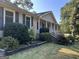 House exterior showcasing landscaping and a covered porch at 6074 Shallow Wood Ln, Douglasville, GA 30135