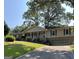 Ranch home with a long driveway and large trees at 6074 Shallow Wood Ln, Douglasville, GA 30135