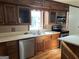 Kitchen with double sink, wood cabinets, and new flooring at 6074 Shallow Wood Ln, Douglasville, GA 30135